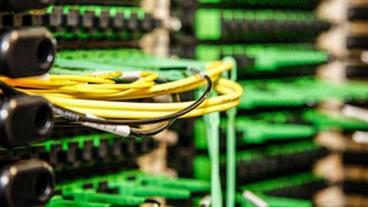 A stack of computer servers with cables.