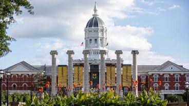 Jesse Hall with the columns and flowers in foreground.