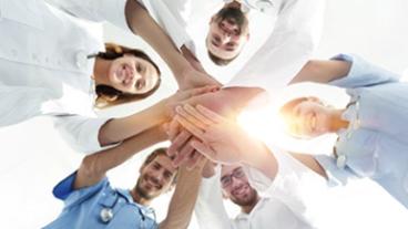 medical people linking hands