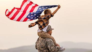 Vet with son on shoulders