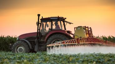 Tractor spraying field