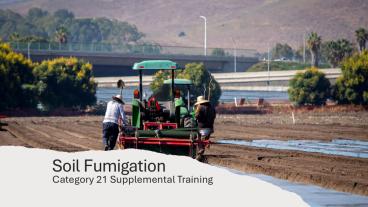 Tractor performing soil fumigation is a field.