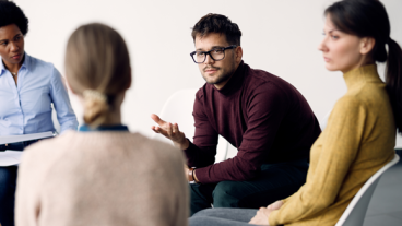 four people having a group discussion