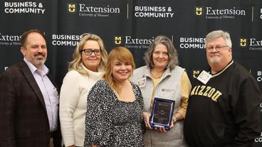 people posing with creator award