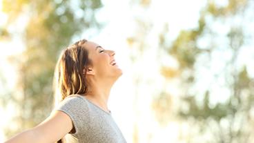 Woman enjoying the sunshine on her face and relaxing