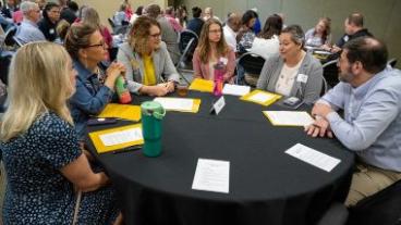 People gathered around a table together at a conference