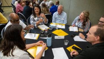 People gathered around a table for a discussion