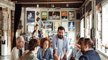 A group of people talking at a table.