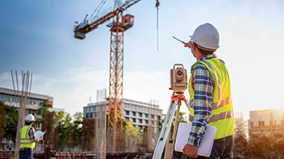 A man drafting on a construction job site.