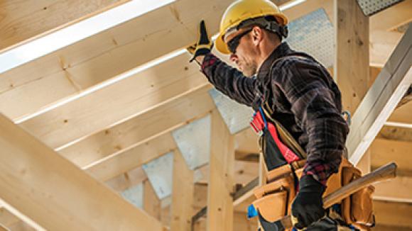 A man in a hard hat overseeing a job site.