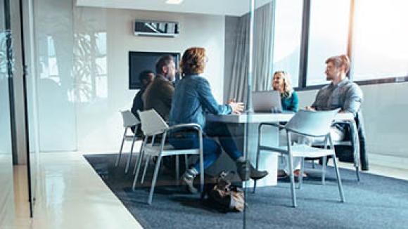A group of professionals sitting in a meeting room.