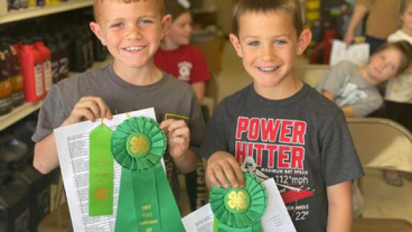 two children smiling with their 4-H awards