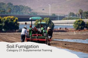 Tractor performing soil fumigation is a field.