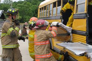 Fire fighters training a school bus rescue.