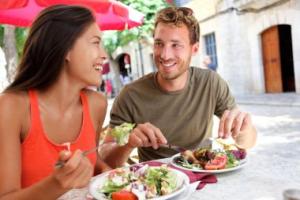 A Couple eating salads at an out door cafe