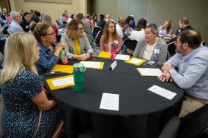 People gathered around a table together at a conference