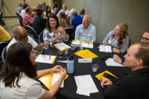 People gathered around a table for a discussion