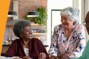 Two elderly women smiling and laughing together