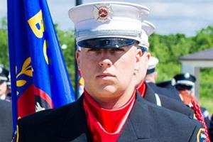 A firefighter graduate at a ceremony.