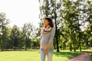 Pregnant woman walking in a park