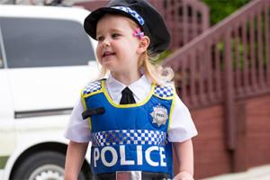 Young girl wearing police uniform