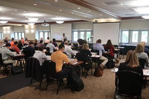 Conference room full of attendees listening to presentation on agriculture topic