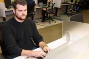 A man typing on a computer.