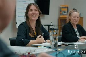 Jenni Nevatt, MU Extension specialist, sitting at a table and having a discussion with class participants