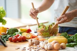 person tossing salad