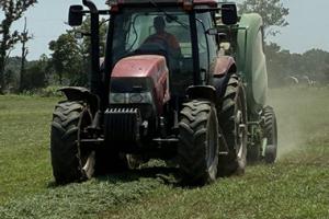 A tractor in a green field.
