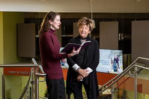 Two women reviewing a booklet together