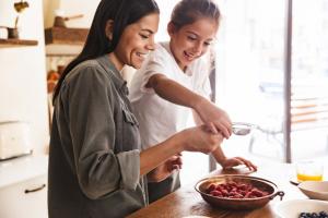 child and adult cooking
