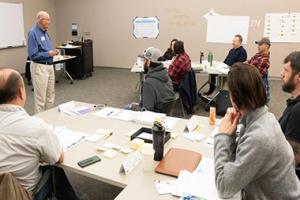 Instructor talking in front of room full of participants