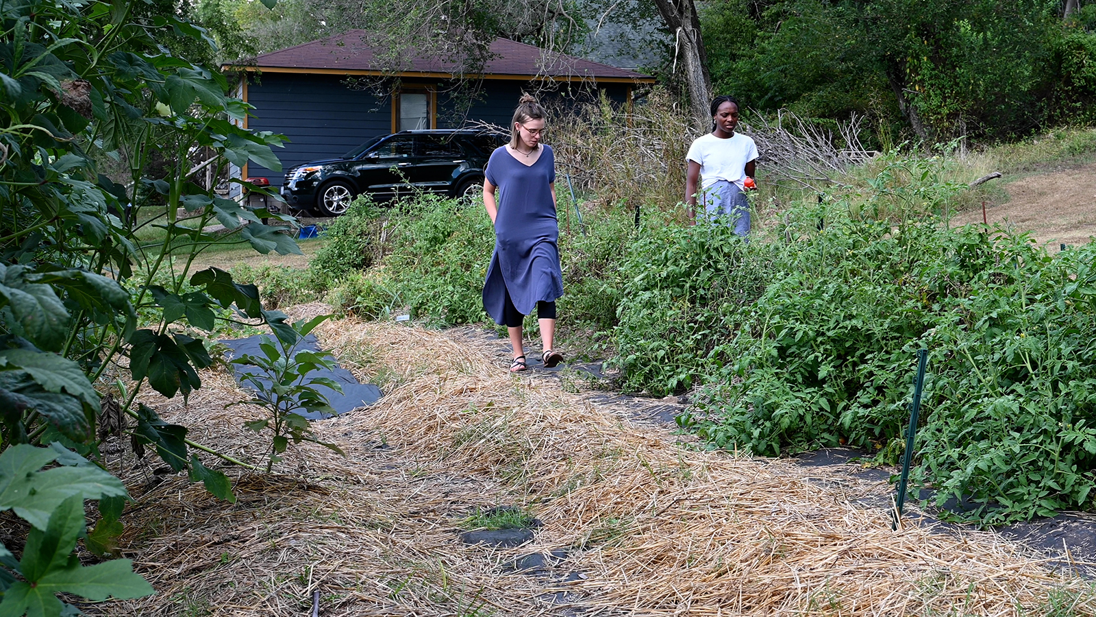 RAISE garden coordinator Destiny Akannam, right, gives a tour of the community garden in Noel, Mo.