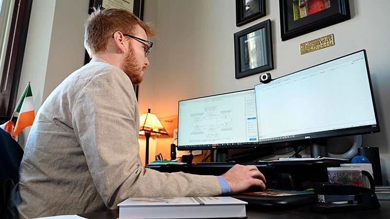 Kale Monk working at his desk