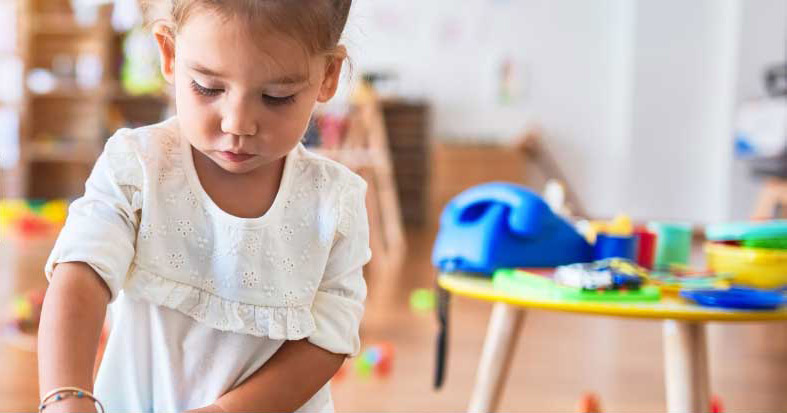 Young child playing in child care center