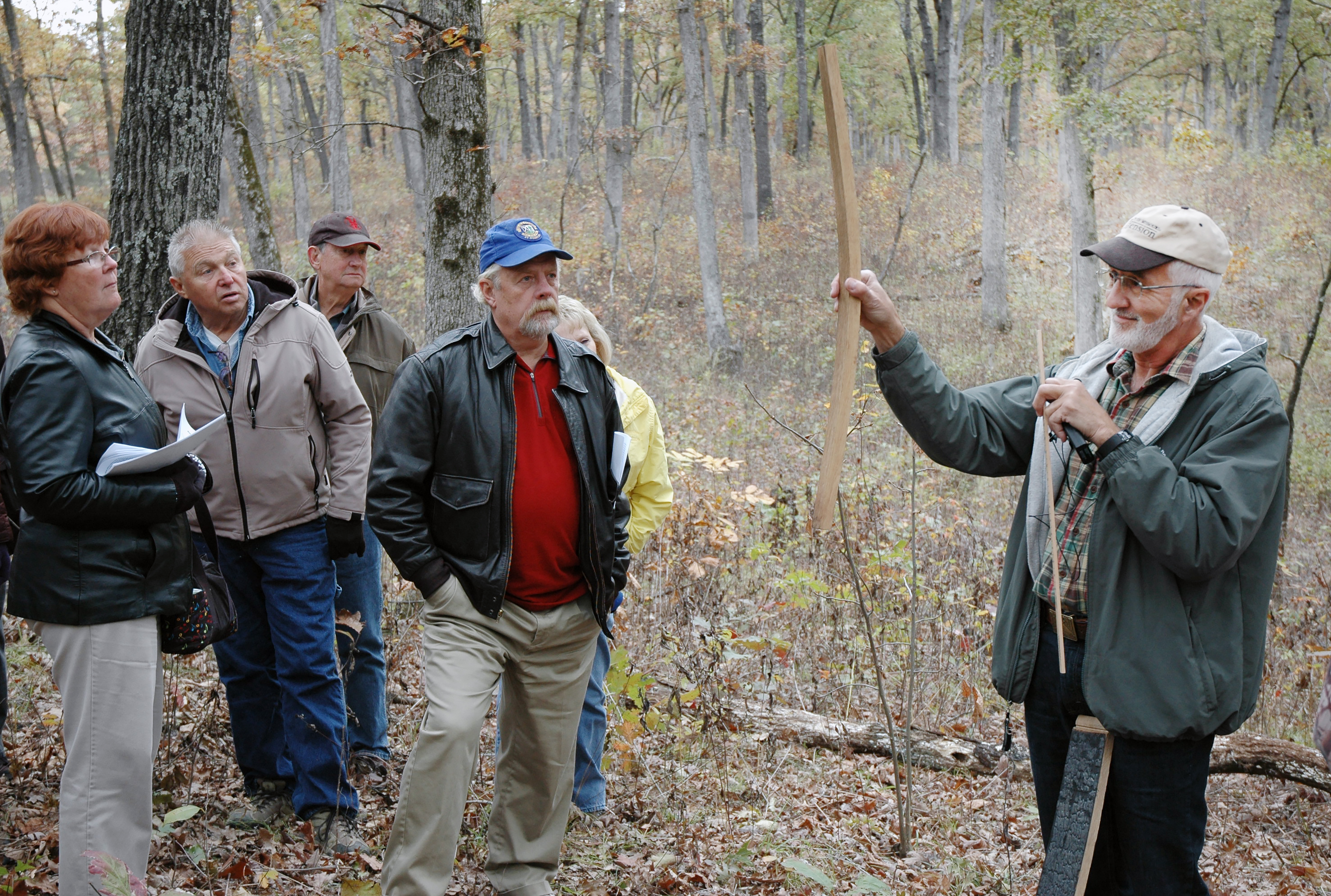 Hank Stelzer, MU Extension forestry state specialist, discusses how white oaks provide wood products such as staves for whiskey and wine barrels at a field day tour. Field days such as this help landowners understand how they can improve conditions for wildlife while also generating revenue through timber sales.