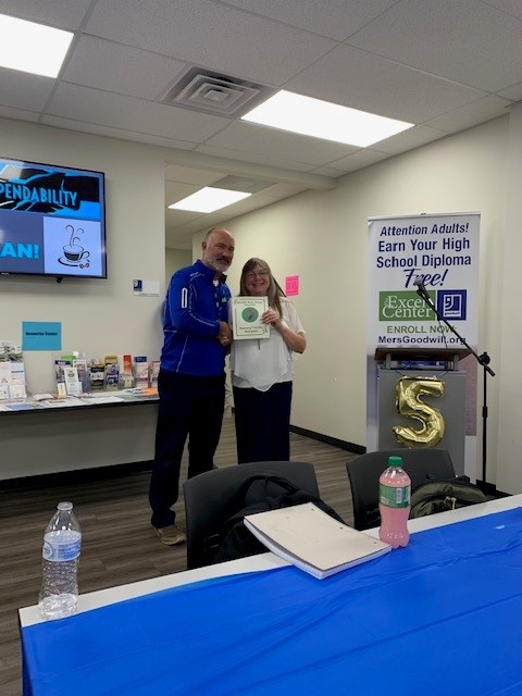 Ann McCauley, director of Missouri’s Recovery Friendly Workplace program, presents Excel Center Director Mike Reynolds with the Recovery Friendly Workplace certificate. 