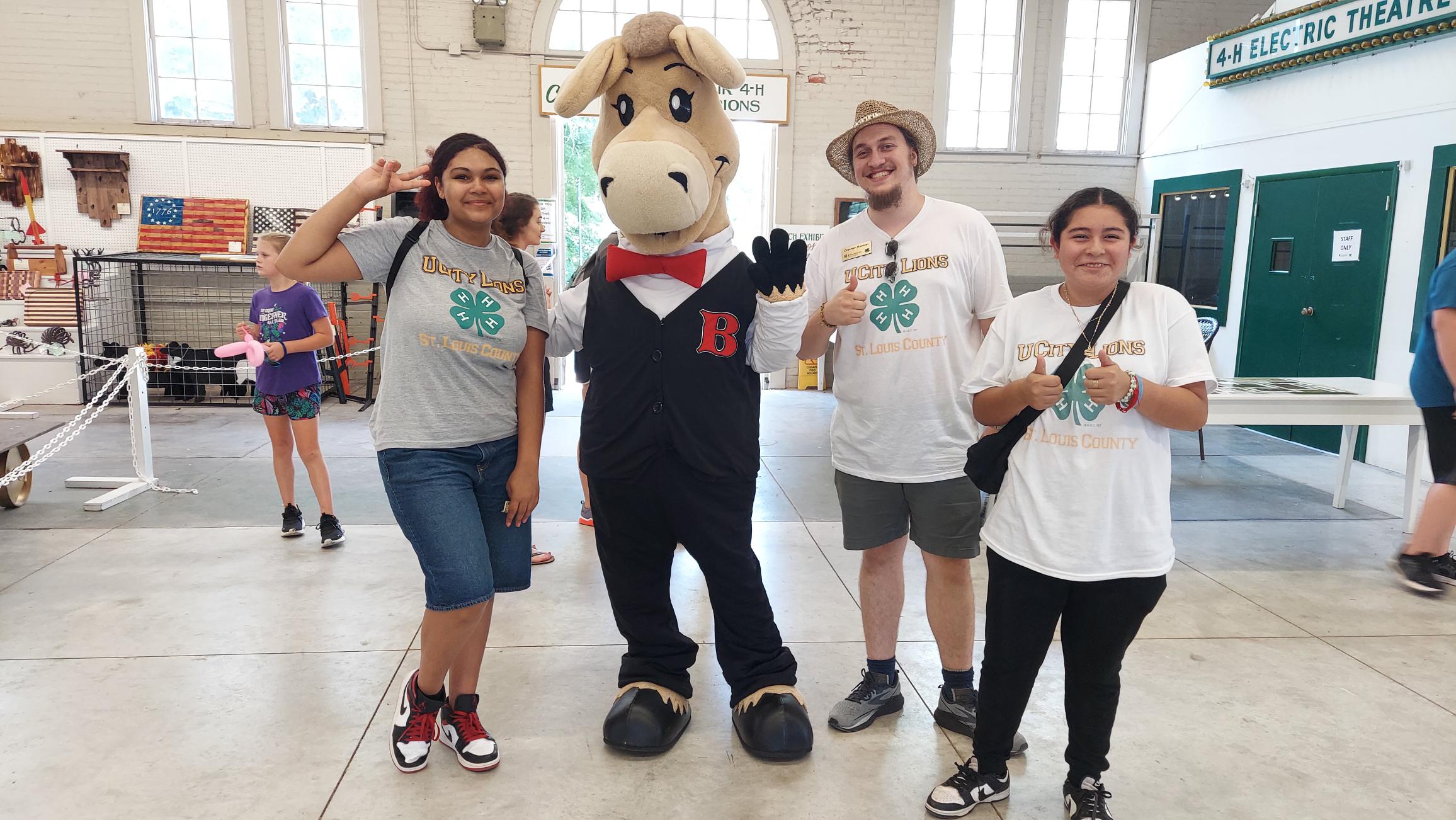 4-H members and staff from St. Louis County and St. Louis City enjoy a day at the fair and pose for a photo with BARTholomule, the Missouri State Fair mascot.