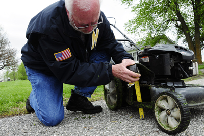 Brad Fresenburg checking the mowing heightRoger Meissen