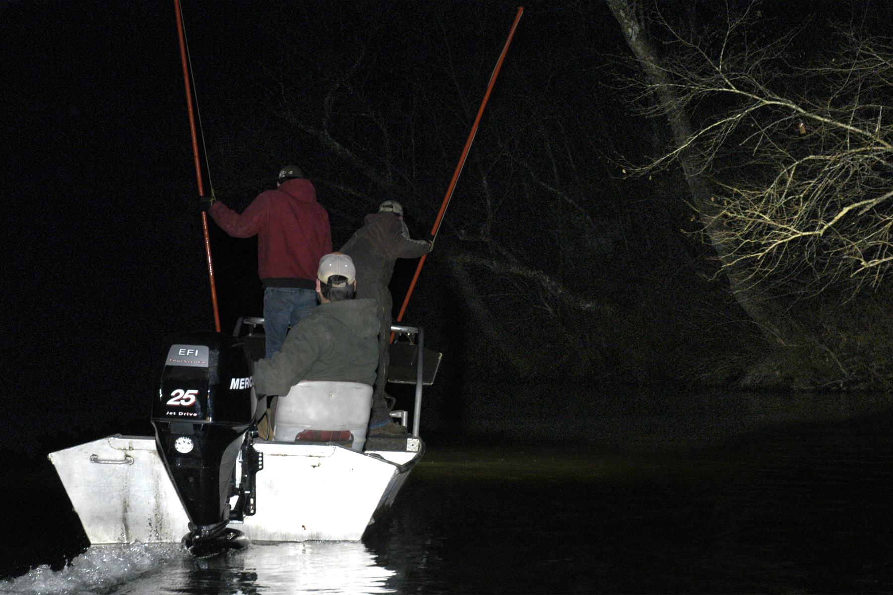 Andrew Stoops, left, and Steven Bird look for sucker fish as Michael Stoops pilots his john boat on the Current River in Shannon County, Mo.MU Cooperative Media Group 