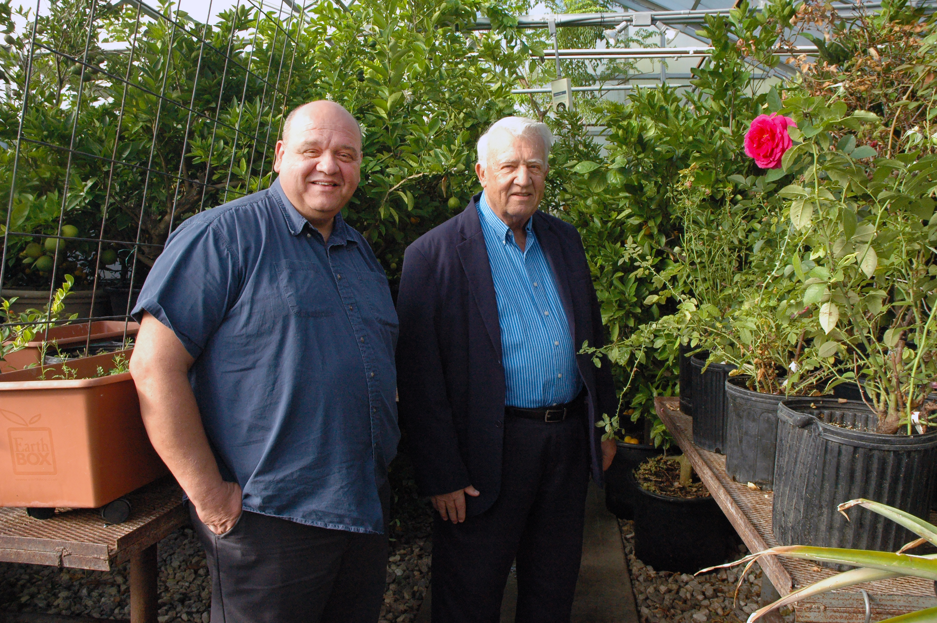 Jim Allphin, left, with his father, Lee. The Allphins enjoy growing fruit and flowers year-round. A large orchard produces apples and other fruits while a garden and greenhouse give them fresh fruit and vegetables. Photo by Linda Geist