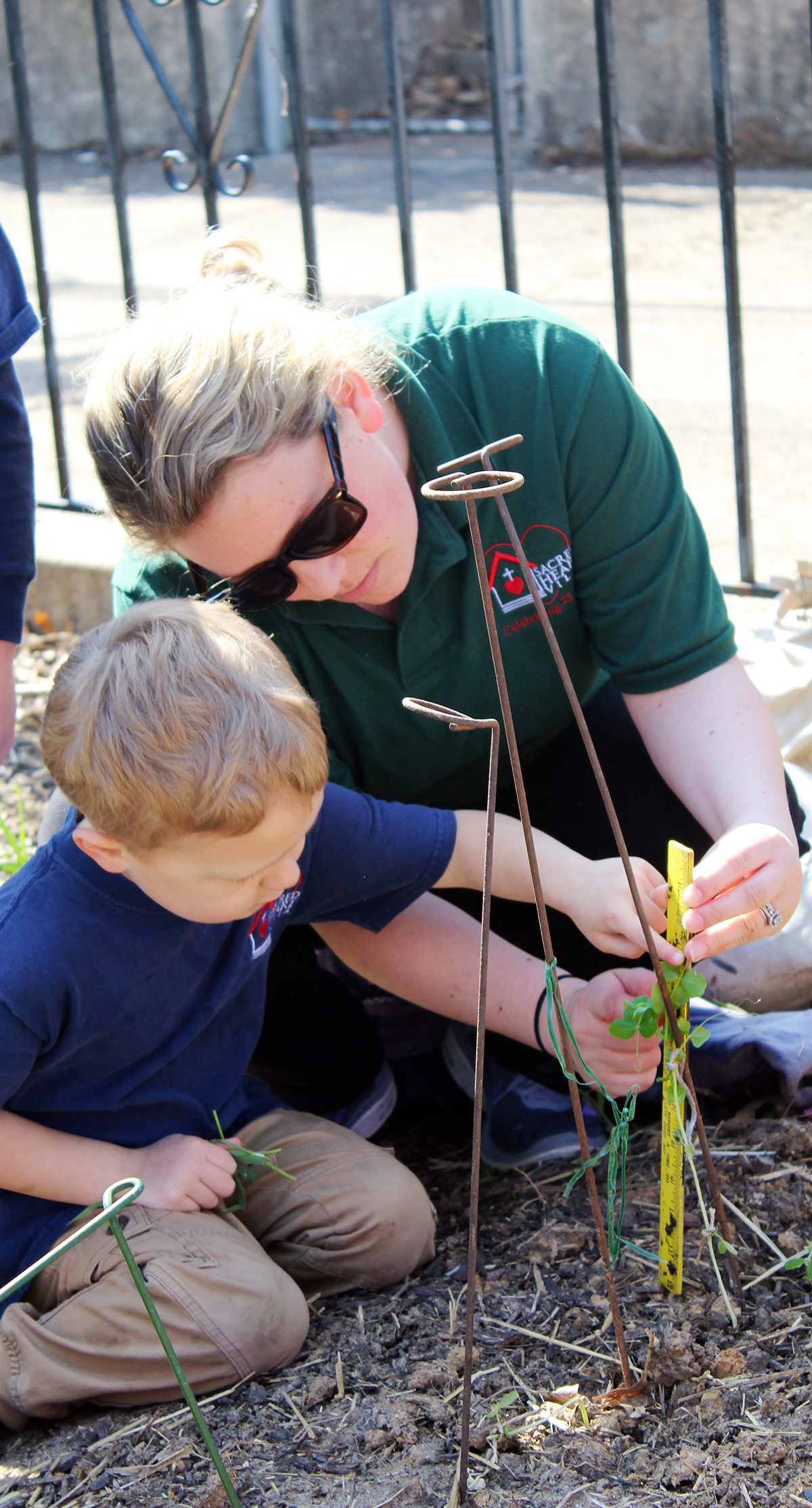 Students learn math and science as part of their gardening experience. Each week, they measure and record the growth of plants. They research what vegetables to grow in the schoolyard. Photo by Linda Geist.